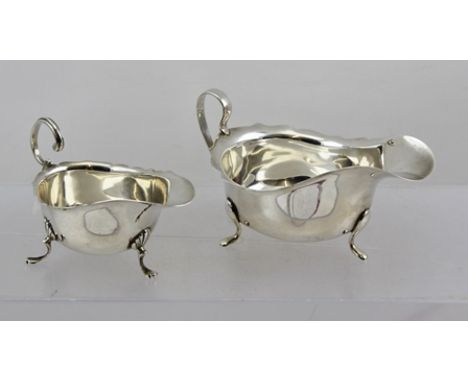 BARKER BROS. A CHIPPENDALE STYLE SILVER SAUCE BOAT, having cut rim, plain belly and loop handle, on three pad feet, Birmingha