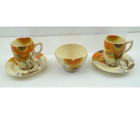 CLARICE CLIFF BIZARRE - A PAIR OF COFFEE CUPS AND SAUCERS together with a SUGAR BOWL, hand-painted in Rhodanthe pattern 