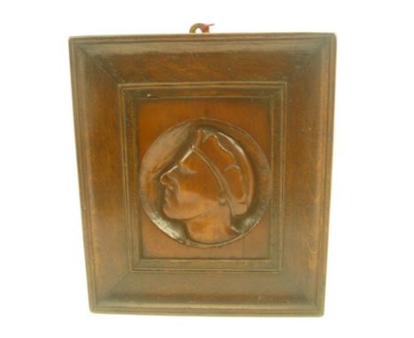 AN EARLY 20TH CENTURY RELIEF CARVED PROFILE PORTRAIT ROUNDEL, set within an oak frame, roundel 10cm diameter, see inscription
