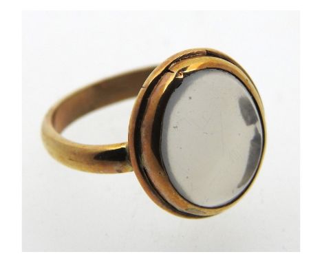 A yellow metal antique ring, tests electronically as 9ct gold, set with possibly moonstone, 3.8g, size N 