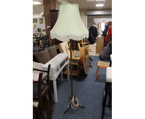AN ART NOUVEAU BRASS LAMP STANDARD WITH A SHADE