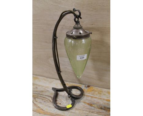 A HANDMADE IRONWORK TABLE LAMP WITH SUSPENDED CUT GLASS SHADE
