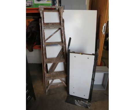 A SET OF VINTAGE WOODEN STEP LADDERS WITH A FOUR WHEEL SACK TROLLEY