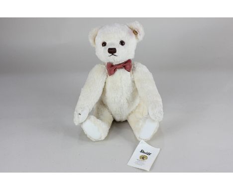 A Steiff Collectors Bear, No.663697, with soft ecru coloured fur, with ear stud, wearing a ribbon, with original paper tag, 2