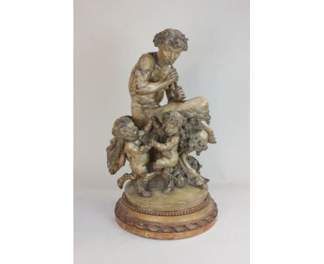 After Claude Michel, known as Clodion, a pottery figure group of Pan playing a pipe beside two dancing fauns, 50cm high, on c