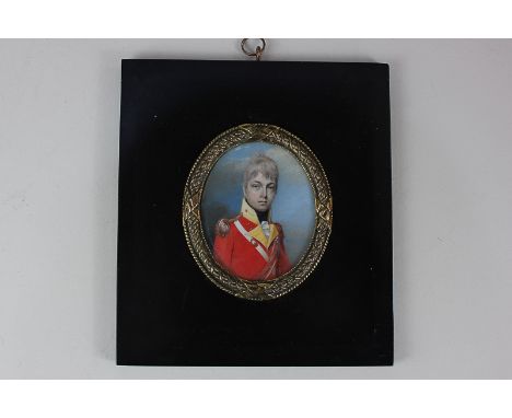 A 19th century oval miniature portrait of an officer dressed in a red tunic, 7.5cm by 6.5cm