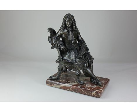 A bronze figure of a seated gentleman in 18th century costume, on rectangular marble base, 31cm high excluding base