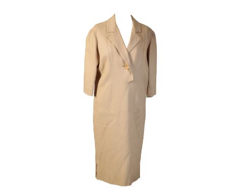A VINTAGE CREAM LINEN DRESS with attached "Christian Dior" label, indistinctly numbered "..452". The dress with single button