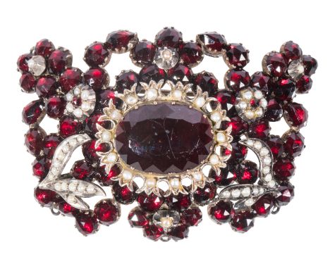 A 19TH CENTURY GARNET AND SEED PEARL BROOCH with enclosed white metal back, 6.4cm wide