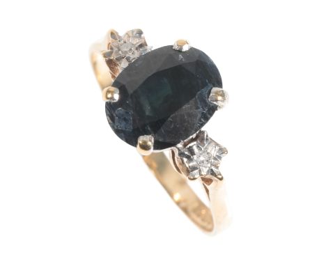 A THREE STONE SAPPHIRE AND DIAMOND RING on a 9ct yellow gold shank, ring size K