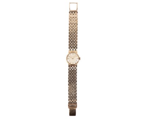 ROTARY: A LADY'S 9CT GOLD BRACELET WATCH with manual wind movement, the white dial with gold baton numerals and gold hands, c