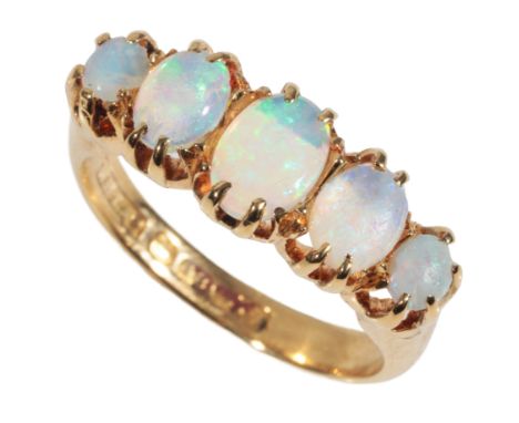 A FIVE STONE OPAL DRESS RING each opal with green/blue hues, on an 18ct yellow gold shank, ring size N