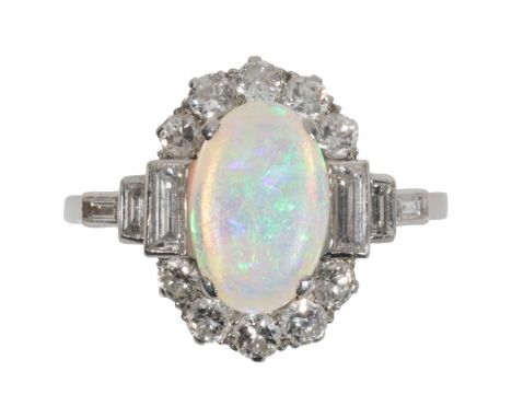 AN ART DECO OPAL AND DIAMOND RING the central oval-cut opal with blue/green hues, within a border of ten brilliant-cut diamon