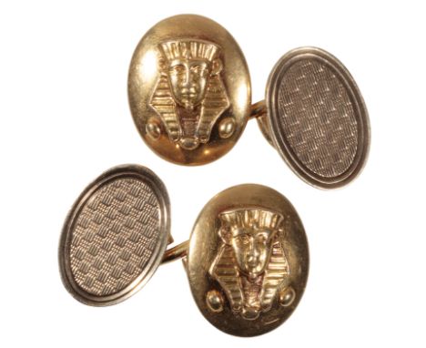 A PAIR OF  GOLD CUFFLINKS the fronts decorated with a pharaoh, stamped "18ct", with chain connections to the engine turned ba