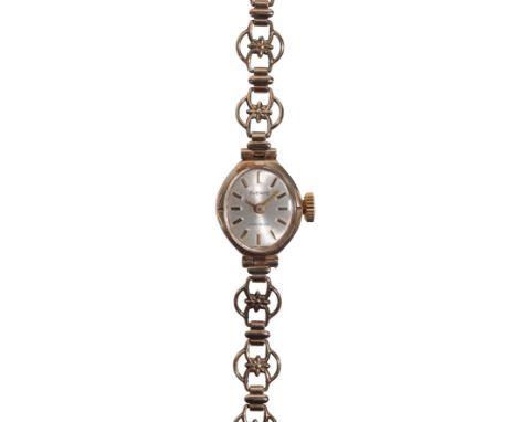 EVERITE: A 9CT LADY'S  GOLD BRACELET WATCH with manual wind movement, the silver dial with gold baton numerals and gold hands