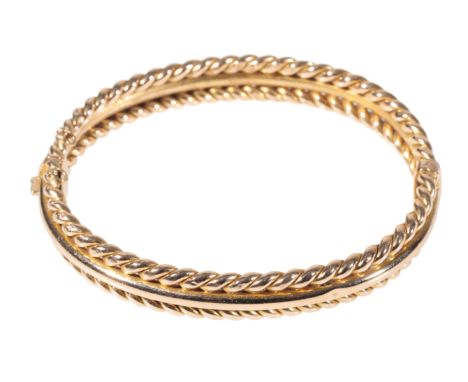 A VICTORIAN HINGED GOLD BANGLE the clasp stamped "15", (c.14.7grams) 