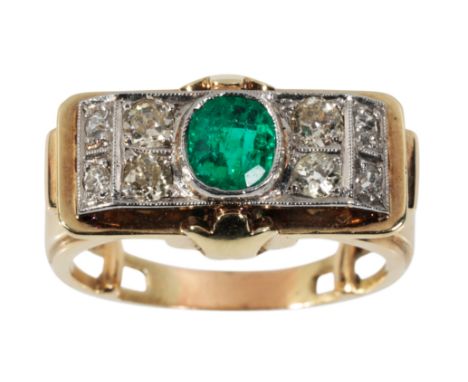 AN EMERALD AND DIAMOND CLUSTER RING the oval-cut emerald, flanked to either side with four graduated brilliant-cut diamonds, 