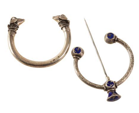 A SILVER TORQUE BANGLE with ram head terminals, (c.68grams), together with a penannular cloak brooch (2)