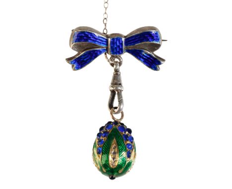 AN ENAMEL, DIAMOND AND SAPPHIRE EGG PENDANT BROOCH attached to silver and enamel bow, with attached safety chain