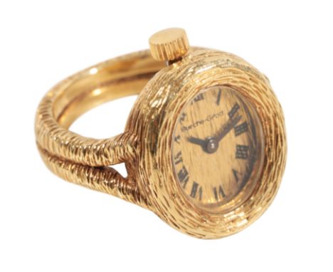 BUECHE-GIROD: AN 18CT GOLD WATCH RING with manual wind movement, the dial with black Roman numerals and dark steel hands, wit