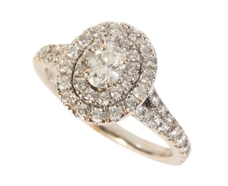A DIAMOND CLUSTER RING the central diamond surrounded by two borders of smaller diamonds, (total diamond weight c.0.80ct), on