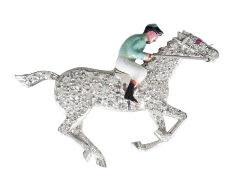 A DIAMOND AND ENAMEL JOCKEY BROOCH the horse with pave-set diamonds and a single ruby eye, with seated enamelled jockey, set 
