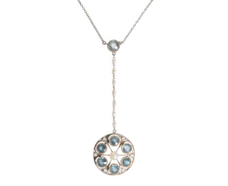AN EDWARDIAN AQUAMARINE AND SEED PEARL PENDANT NECKLACE the circular openwork aquamarine and seed pearl pendant suspended fro