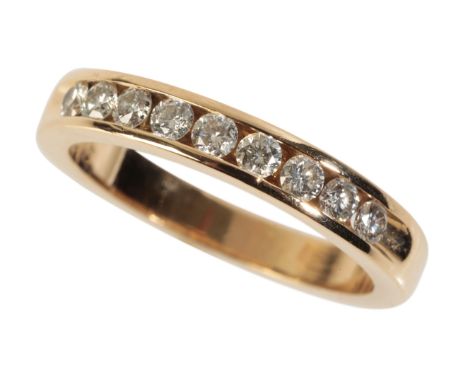 A DIAMOND HALF ETERNITY RING the diamonds channel-set in 14k yellow gold, ring size K-L
