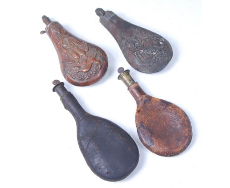 A 19th century leather shot flask, 22cm, together with one other leather shot flask and two copper powder flasks. (4)