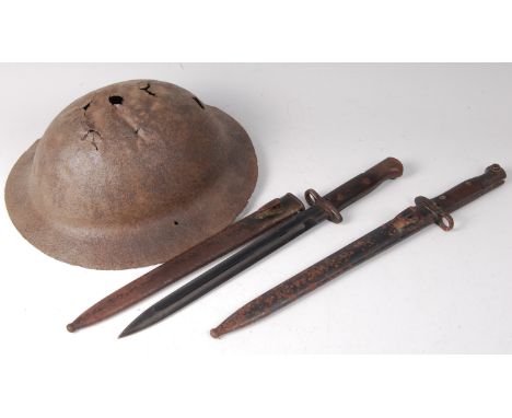 A German MP34 bayonet, the 28cm single edged fullered blade stamped to the ricasso Simpson & Co Suhl, having a two piece wood