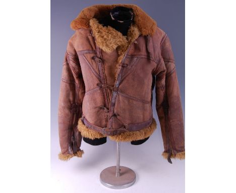 A gentleman's brown leather and fur lined flying jacket, having front strap fastenings and zips to the sleeves, bearing a lab