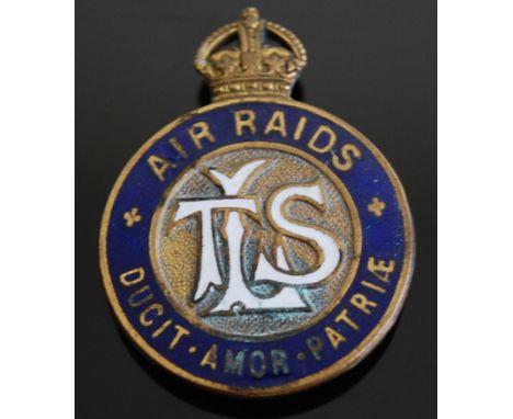 A WW I London Transport Service enamelled badge, having central LTS monogram within a blue border Air Raids, Ducit Amor Patri