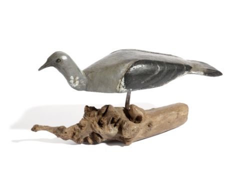 A FOLK ART CARVED AND PAINTED PINE DECOY PIGEON FIRST HALF 20TH CENTURY with glass eyes, mounted on a root wood base 17.5cm h