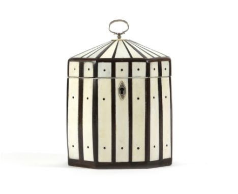 λ A GEORGE III IVORY OCTAGONAL TEA CADDY C.1790 with ebony stringing and silver mounts, the lock stamped with maker's mark 'C