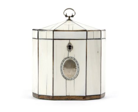 λ A GEORGE III IVORY DODECAGONAL TEA CADDY C.1790 with tortoiseshell stringing and silver mounts, unmarked, the front with a 