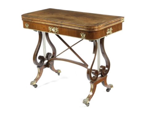 λ A REGENCY ROSEWOOD AND BRASS MOUNTED CARD TABLE IN THE MANNER OF JOHN MCLEAN, EARLY 19TH CENTURY inlaid with stringing and 
