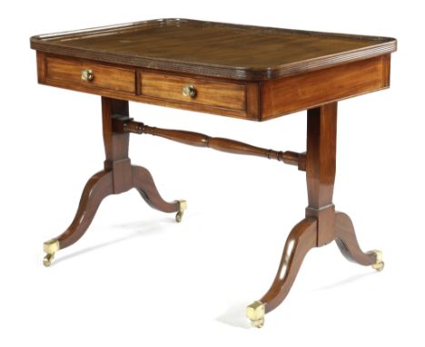 A REGENCY MAHOGANY LIBRARY TABLE EARLY 19TH CENTURY with a reeded edge dished top, above a pair of frieze drawers, with false