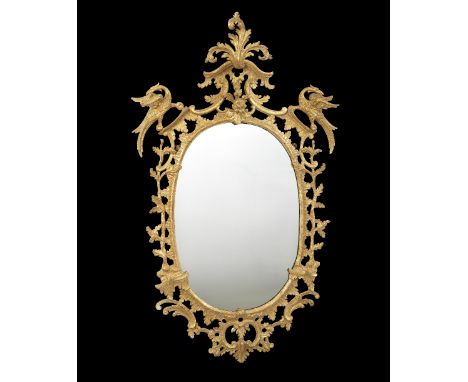 AN EARLY GEORGE III GILTWOOD WALL MIRROR CHIPPENDALE PERIOD, C.1765 the later oval plate in a leaf, branch, 'C' scroll and ro