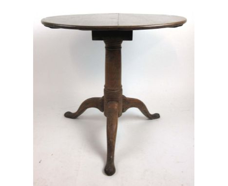 A mid 18th century oak tilt top tripod table with baluster turned column on three splay legs, h. 68 cm, dia. 73 cm CONDITION 