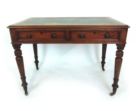 A Victorian mahogany writing table, the moulded top with tooled green leather insert over two drawers on turned legs with cer