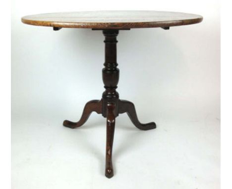 An 18th century oak tripod table, the circular top on turned column and three splay legs, h. 72 cm, dia. 85 cm CONDITION REPO