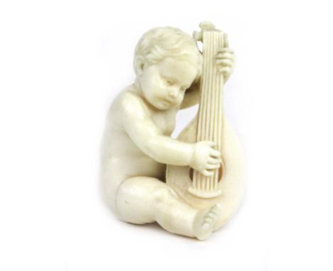 A 19th century fine worked ivory figure of a cherub playing a lute, h. 5cm    CONDITION REPORT:  In need of a cleanAppears go