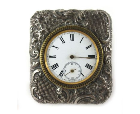 An embossed silver hallmarked enamelled face brass travelling clock, hallmarked Birmingham 1911   