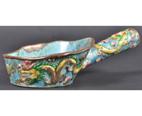 An early 20th Century Chinese Canton enamel silk / clothes iron having hand painted relief decoration depicting dragons chasi
