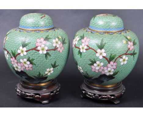 A pair of 20th Century Chinese cloisonne enamel ginger jars and covers. Both having a green ground with intricate woven wire 