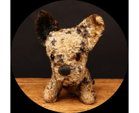 A 1930's Merrythought 'Booboo' type novelty seated dog, mottled black and cream, amber and black glass eyes, brown vertically