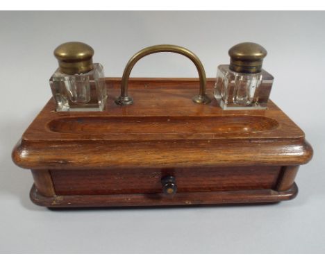 A Late Victorian Desk Top Ink Stand with Two Bottles, Pen Recesses and Base Drawer.