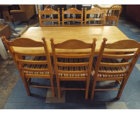 A Rectangular Kitchen Table and Six Ladder Back Dining Chairs. 