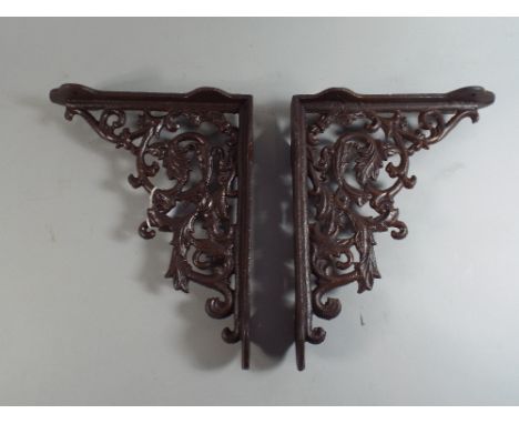 A Pair of Mounted Cast Iron Shelf Brackets. (Plus VAT).