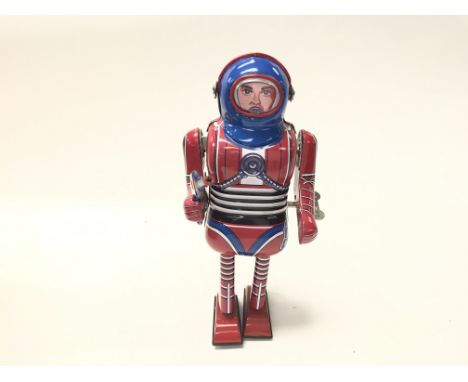 A Vintage clockwork Tin Plate Spaceman by Schylling with box.